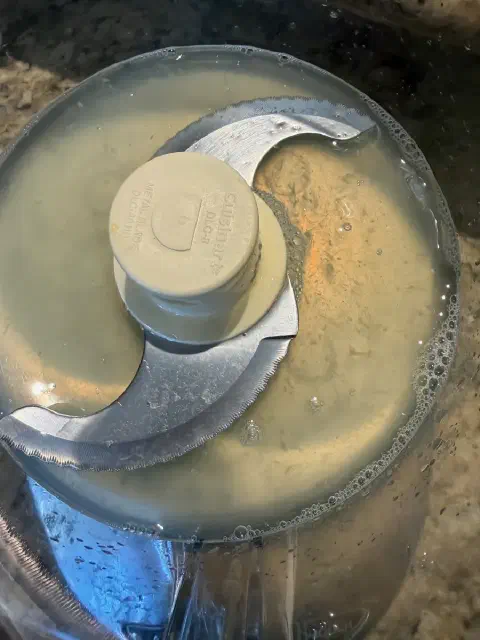 Lemon juice in the food processor bowl, just covering the bottom blade